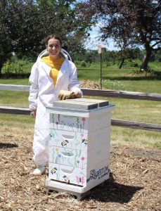a photo of a girl in a beekeeper suit