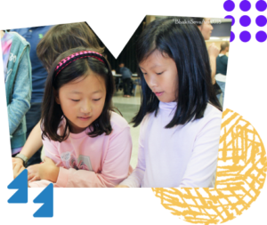 Two children focus on a puzzle. Bright colors and shapes frame the photo.