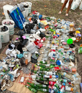 Assorted litter, a heap of bottles, cans, and wrappers. 