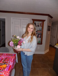 3. A young person holds a bouquet of flowers